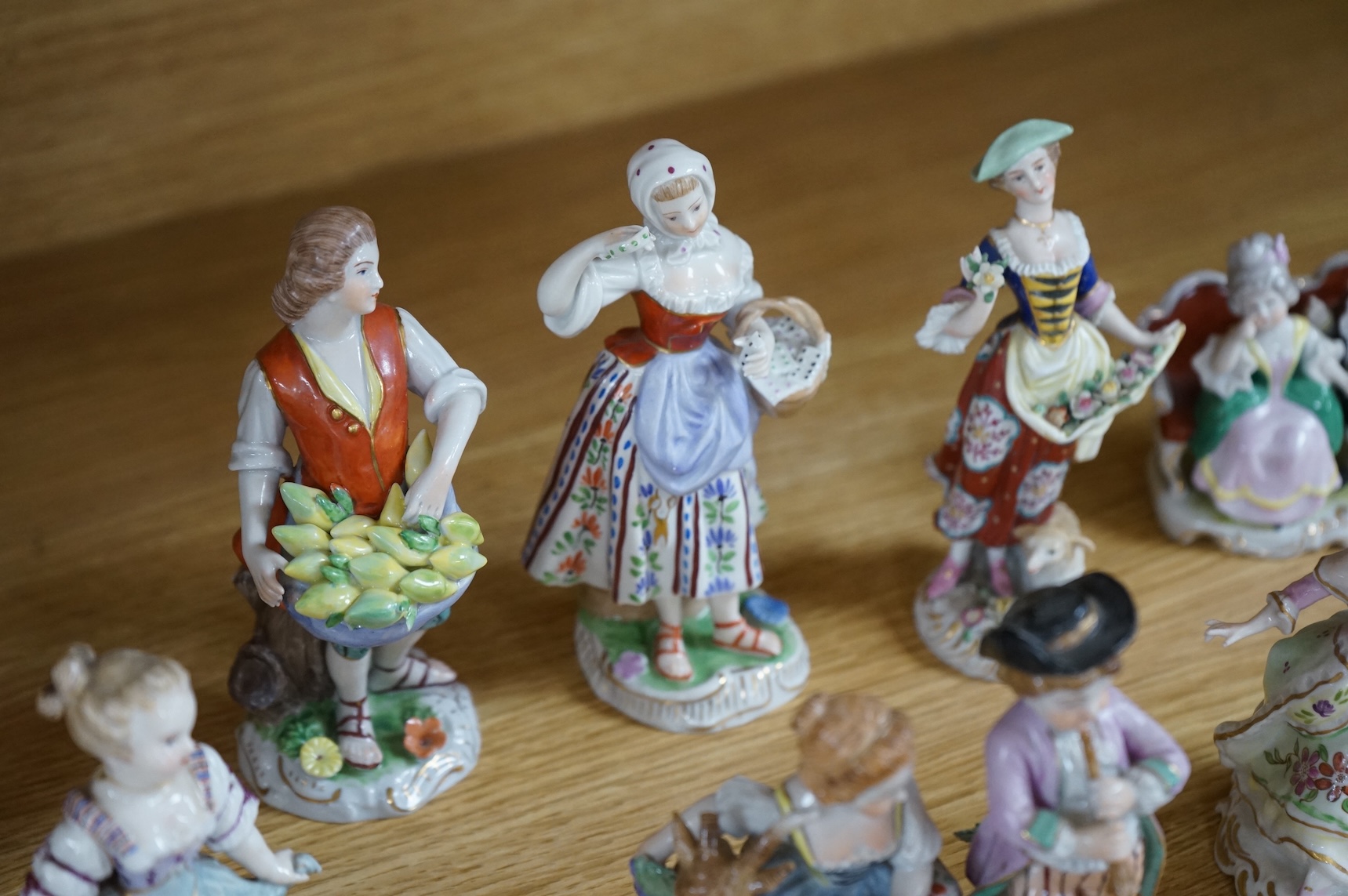 A collection of ten German and English porcelain figures and figure groups, mainly late 19th century, to include Dresden, largest 17cm high